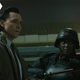 Tom Hiddleston in his TVA jacket and Wunmi Mosaku in combat ready armor and helmet with weapon as Loki and Hunter B-15 in Marvel's Loki